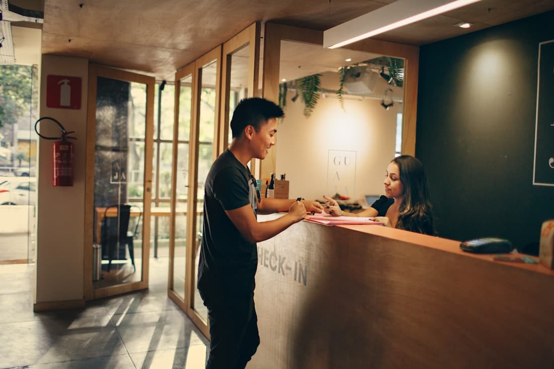 A customer checking in at a reception desk